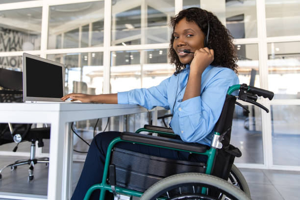 istock Disabled woman talking with clients over the phone from her office using headset 2174298377