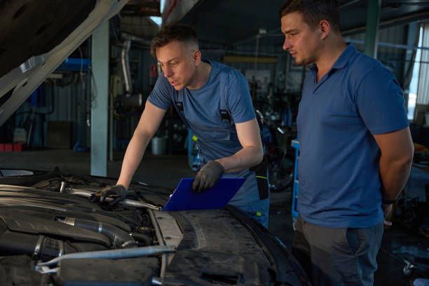 istock Mechanic shows the car engine to the client 2174299525