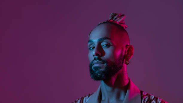 istock Neon light studio close-up portrait handsome black gay man looking camera. 2174300211