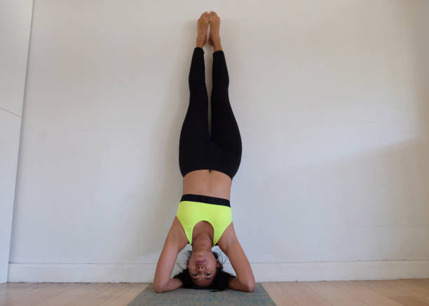 istock Indonesian Woman Practicing Headstand at Home 2174300237
