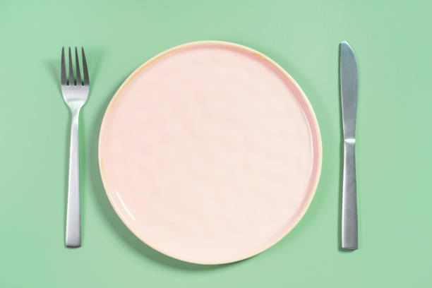 istock Empty pink plate on green background top view close-up. 2174301503