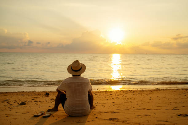 Mid adult man enjoying the sunset at a beach