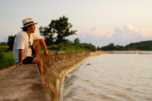 Mid adult man enjoying the sunset at a beach