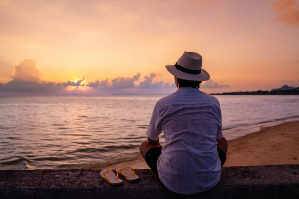 Mid adult man enjoying the sunset at a beach
