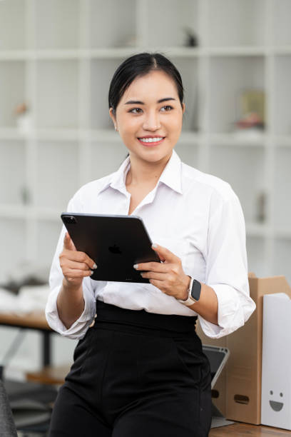 istock Asian business woman using digital tablet and laptop computer, working at office. 2174307524