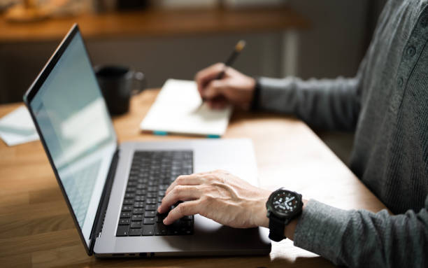 istock Man hands working on laptop computer with paperwork in home office for bookkeeping, payroll or monthly profit. Finance, administration and business person with computer for accounting, planning budget 2174308395