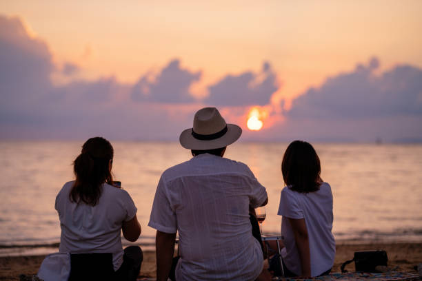 istock Three mid adult friends watching the sunset 2174309533