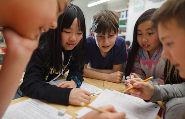 istock Group of multiracial elementary school students talk and enjoy studying together in a classroom 2174314566