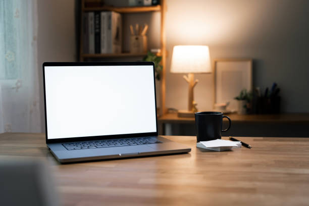 istock Mockup blank white screen laptop computer on wooden table in home office room. 2174315029