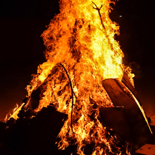 istock Fire flames on black background, Blaze fire flame texture background, Beautifully, the fire is burning, Fire flames with wood and cow dung bonfire 2174316891