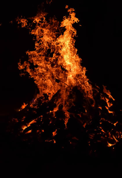 istock Fire flames on black background, Blaze fire flame texture background, Beautifully, the fire is burning, Fire flames with wood and cow dung bonfire 2174316940