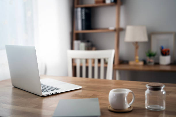 istock Mockup blank white screen laptop computer on wooden table in home office room. 2174317123