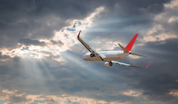 istock Airplane flying over tropical sea at sunset 2174320625