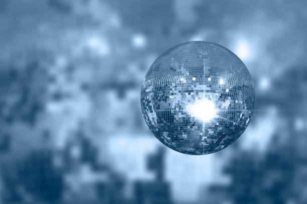 Party disco mirror ball reflecting orange and green lights