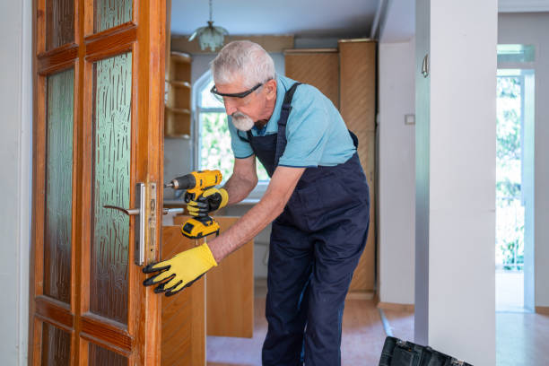 istock Senior Worker Installing New Lock With Cordless Drill 2174323243
