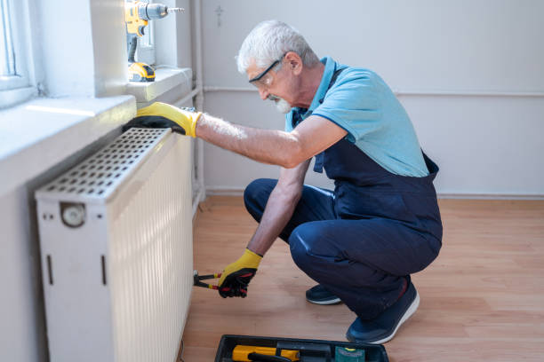 istock Senior Plumber Installing Radiator At Home 2174323451