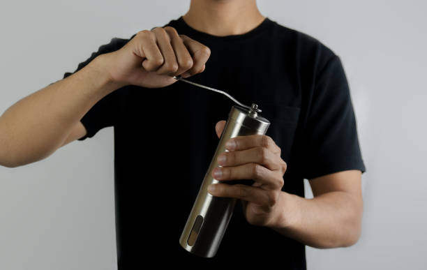 istock Barista Grinding Fresh Coffee Beans With Manual Grinder on isolated white background 2174323936