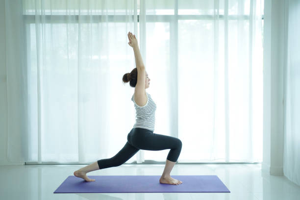 istock Asian woman practices yoga exercise at home. 2174325138