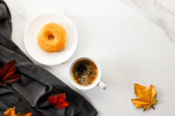 istock Cup of black coffee, Donut, leaves, on white marble background. Autumn composition. Copy space. Flat lay. Top view. 2174327917