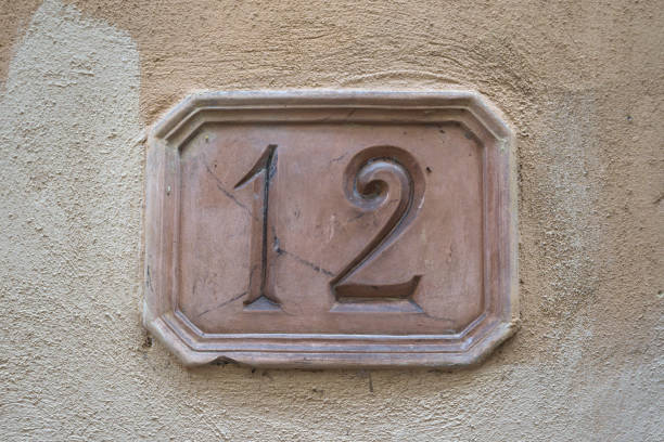 istock Number twelve carved into a terracotta plate 2174329925