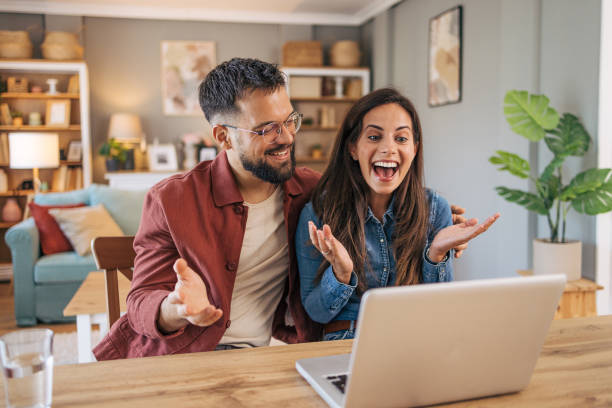 istock An adult cheerful couple using a laptop for a video call. 2174330824