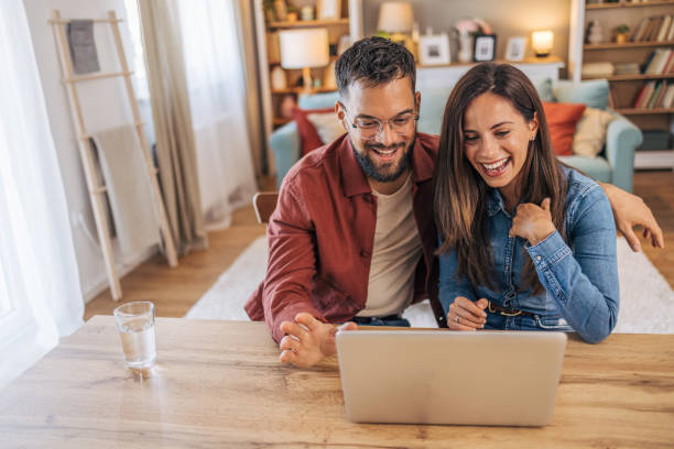 istock An adult cheerful couple using a laptop for a video call. 2174331163