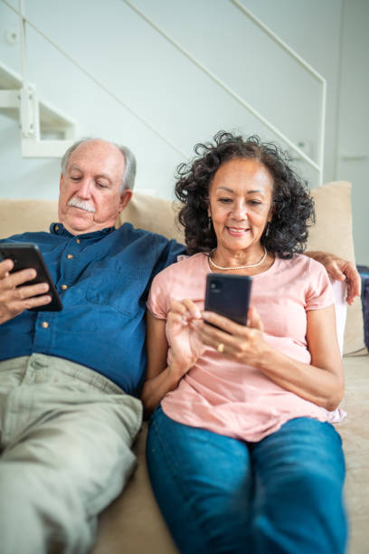 istock Senior Couple Engages with Technology at Home 2174331411
