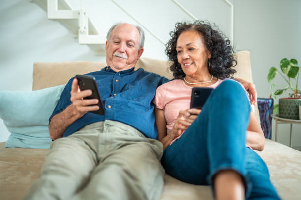 istock Senior Couple Engages with Technology in Home Setting 2174331615