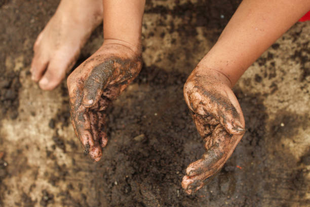 istock small child's hands playing with sand and mud. child playing outdoors with mud 2174331736