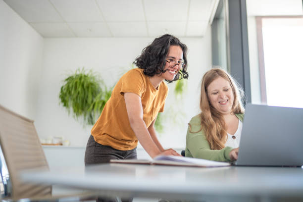 istock Caucasian And Hispanic Businesswomen Collaborating Happily At Work 2174331985