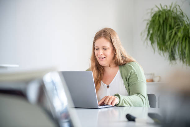 istock Focused Caucasian Businesswoman Using Laptop In Modern Office 2174332028