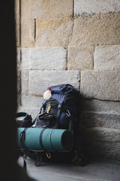pilgrims' backpacks piled up at the door of a pilgrims' hostel on the Camino de Santiago.