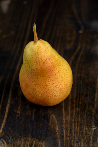 istock fresh red pear with yellow color on the table 2174335268