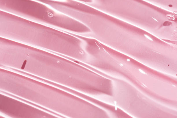 istock Close-up image displaying a pink pure gel texture with glossy highlights and clear droplets, ideal for background use 2174335555