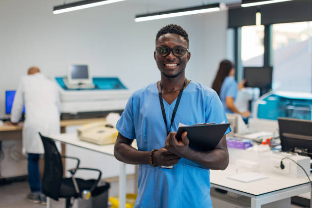 istock Confident black technician holding clipboard in hands while standing in laboratory 2174336218