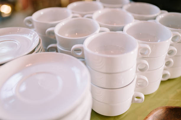 istock Dozens of plates and bowls neatly arranged on a dining table, creating a setting for a large gathering. 2174338215
