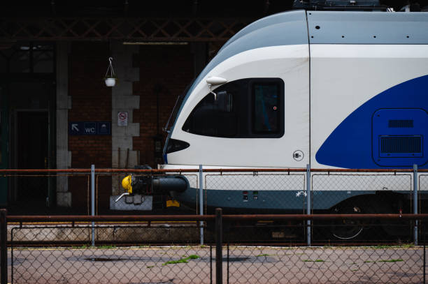 Blue and white passenger train at railway station platform