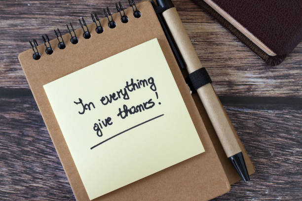 istock In everything give thanks, inspirational handwritten text on notebook with pen and holy bible book 2174343694