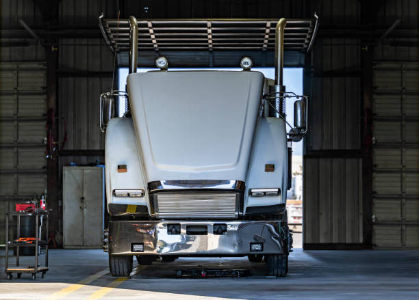 istock Powerful white big rig semi truck tractor with open hood standing in Mechanical workshop for inspection and maintenance 2174344533