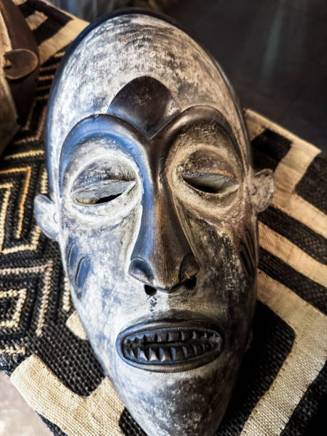 Traditional Angolan mask displayed on woven textile in Luanda showcasing rich cultural heritage and craftsmanship