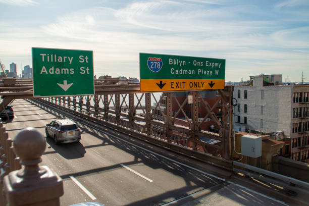 New York, USA. 11 09 2019. Traffic signs indicating exits and vehicles circulating on the Brooklyn Bridge. Traffic signs at the entrance to the Brooklyn Bridge in Manhattan.