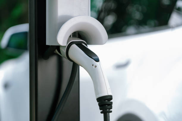 istock Closeup EV charging station with charger plug connected power sauce. Synchronos 2174347134