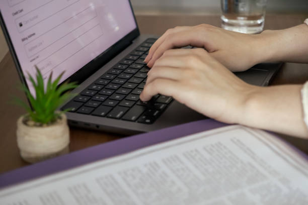 istock A woman types on a laptop and works remotely from home. Working with documents 2174347564