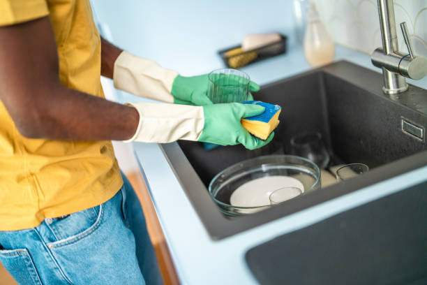 istock Diligent Black Man Washing Dishes in Modern Kitchen 2174349301