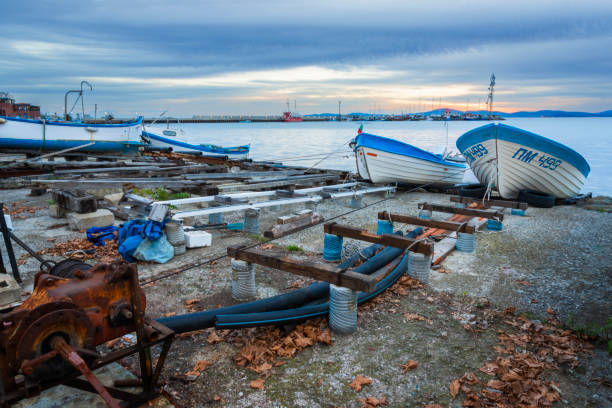 Pomorie town, Bulgaria - November 12, 2023:  Boats on the shore in Pomorie town, before the sunset. Burgas province, Bulgaria, Eastern Europe.