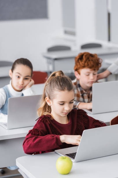 istock Engaged schoolchildren collaborating on digital assignments in a contemporary classroom 2174361555