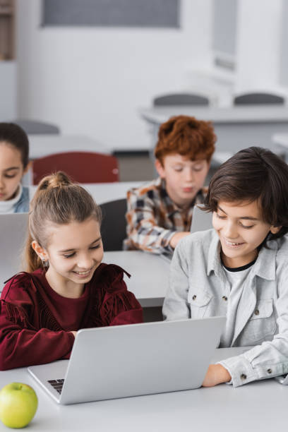 istock Engaged schoolchildren collaborate and learn together in a modern classroom during study time 2174361557