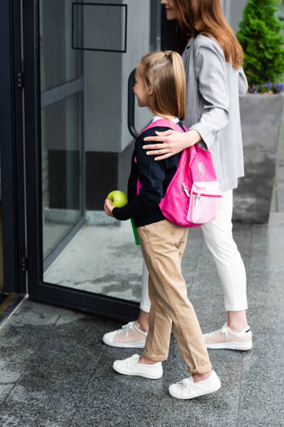 istock mother entering school together with daughter 2174362709