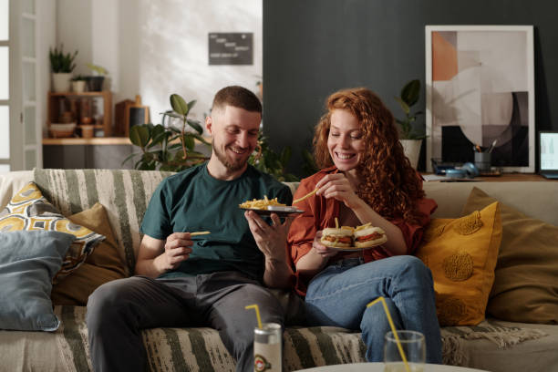 istock Guy sharing french fries with girlfriend 2174363876