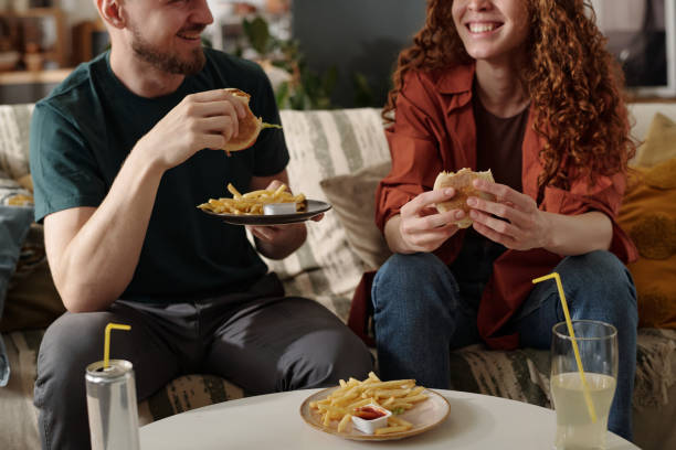 istock Couple having junk food for lunch 2174363901